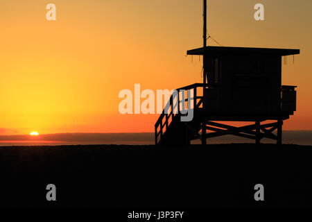 Lifeguard station watching a sunset over the pacific ocean Stock Photo