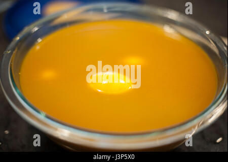Soaking Eggs in Turmeric and Vinegar to Color Easter eggs Naturally Stock Photo