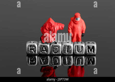 Miniature scale model team in chemical suits with the word radium on beads Stock Photo