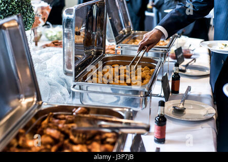 BBQ Chicken wings and nuggets with a spicy sauce during a business meeting buffet Stock Photo