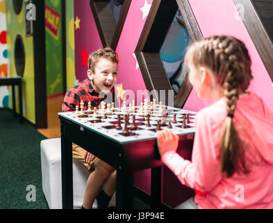 Little kids playing chess in entertainment center. Happy childhood. Adventure time Stock Photo