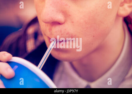 Kursk, Russia - April 24, 2017: Young man drink cola in fast food Stock Photo