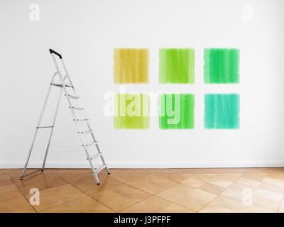 room with ladder and colored paint samples on wall Stock Photo