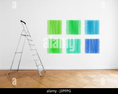 empty room with ladder and colored paint samples on wall Stock Photo