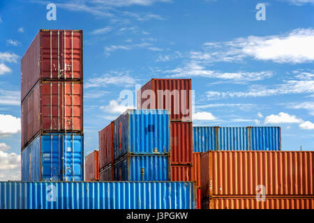 Stack of Cargo Containers in an intermodal yard with blue sky Stock Photo