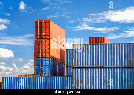 Stack of Cargo Containers in an intermodal yard with blue sky Stock Photo