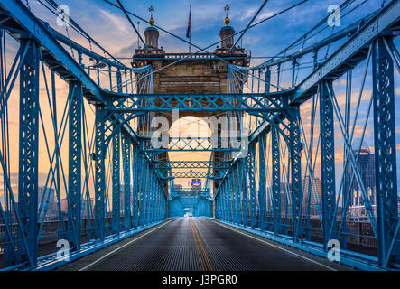 The John A. Roebling Suspension Bridge spans the Ohio River between Cincinnati, Ohio and Covington, Kentucky. When the first pedestrians crossed on De Stock Photo