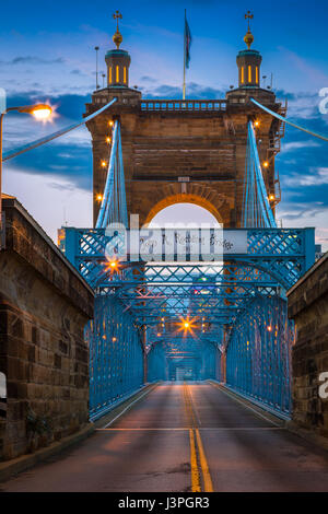 The John A. Roebling Suspension Bridge spans the Ohio River between Cincinnati, Ohio and Covington, Kentucky. When the first pedestrians crossed on De Stock Photo