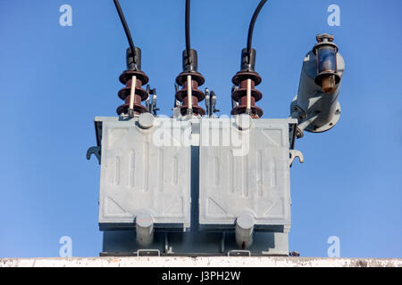 gray transformer on substations with blue sky Stock Photo