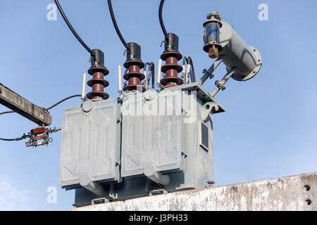 gray transformer on substations with blue sky Stock Photo