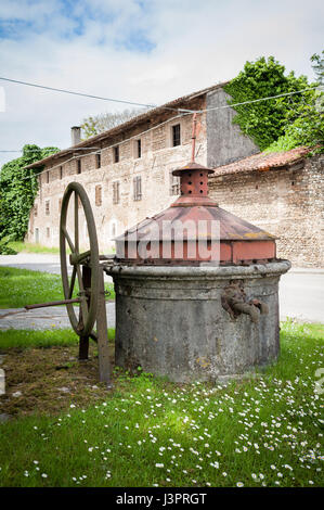 Old well covered with hand pump. It needed around the country. Stock Photo