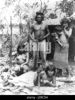 Indian family in Brazil posed in front of hut Stock Photo