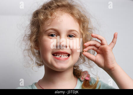 Portrait of cute six years girl losing her first milk tooth Stock Photo