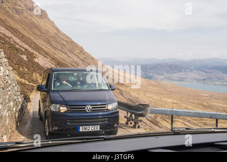 Bealach na Ba - camper van using passing place - viewed through windscreen of oncoming vehicle, Scottish Highlands, UK