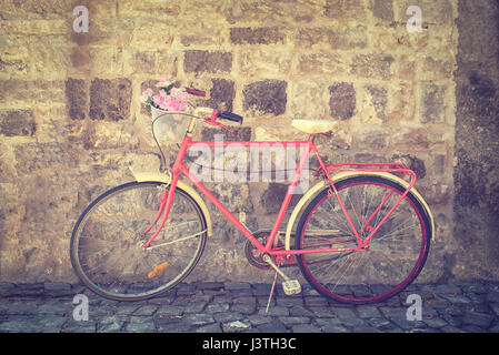 Old retro bicycle against brick wall Stock Photo