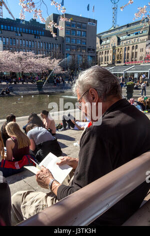 Man reading and relaxing in spring weather Stock Photo