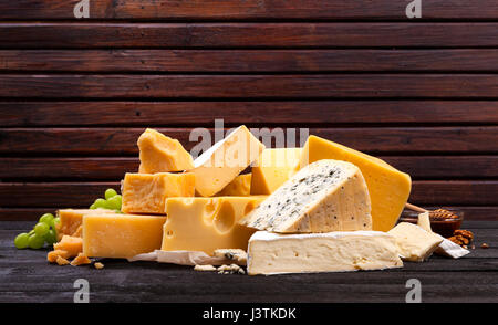 Brie type of cheese set, on black wooden table, flat lay with copy ...