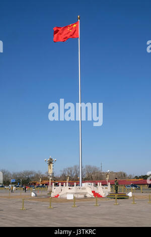 Soldiers guard the Chinese flag in Tiananmen Square. It's the third largest square in the world, Beijing Stock Photo