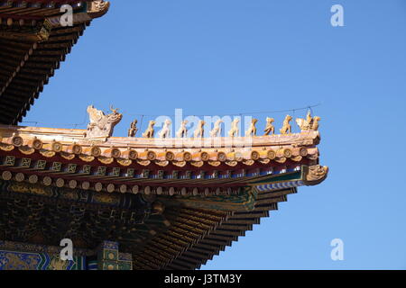 Tiled roof and facade decorated with a Chinese pattern. Palace in The Forbidden City, Beijing, China, February 23, 2016. Stock Photo