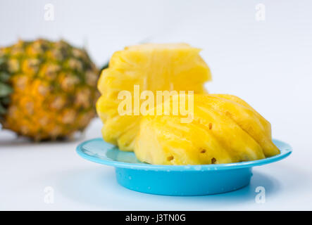 sliced pineapple on blue background Stock Photo - Alamy