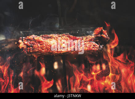 steak with flames on grill Stock Photo