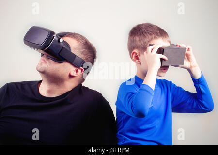 Man and kid using VR glasses together Stock Photo