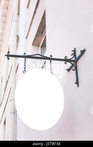 Mock up sign. Blank white rounded signage on a building wall Stock Photo