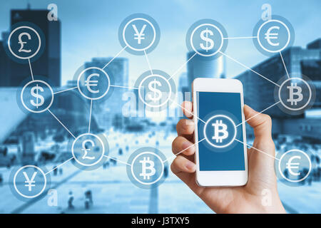 Bitcoin cryptocurrency and blockchain concept for digital payment with a person using a smartphone, city bakground and a network of connected currency Stock Photo