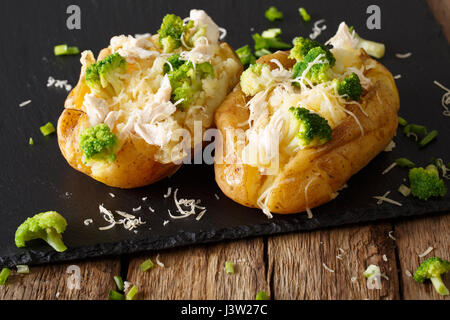 Homemade baked potato with broccoli, chicken and cheese closeup on the table. horizontal Stock Photo