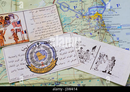 Psyops Leaflets encouraging Iraqi forces to surrender to Coallition forces during the Gulf War of 1990-1991, seen over an air map. Stock Photo