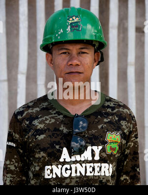 Philippine Army personnel participate in Balikatan 2017 at Ormoc City, Leyte, on April 27, 2017, collaborating with U.S. military engineers to construct classrooms at Margen Elementary School during the bilateral exercise focused on humanitarian assistance, disaster relief, and combined operations. Stock Photo