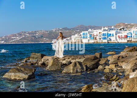 Young woman on the beach in white dress Stock Photo