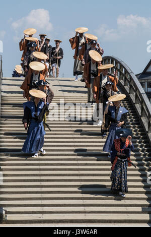 Participants cross the Kintai Bridge during the 40th Annual Kintai Bridge Festival in Iwakuni City, Japan, April 29,, 2017. The festival gives Marines to take an active part in celebrating the history of Iwakuni by donning traditional Japanese attire and crossing the Kintai Bridge. Events like these help Marines learn more about the history of Japan, while creating positive interactions with their Japanese hosts. (U.S. Marine Corps photo by Sgt. Nathan Wicks) Stock Photo