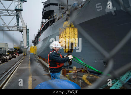 PORTLAND, Ore. (May 2, 2017) - A civilian contractor prepares to remove mooring lines for the submarine tender USS Frank Cable (AS 40) before her transition to dry dock, with Vigor Industrial in Portland, Ore., May 2nd. Frank Cable is in Portland, Ore. for a scheduled dry-dock phase maintenance availability.  (U.S. Navy photo by Mass Communication Specialist 3rd Class Alana Langdon/Released) Stock Photo