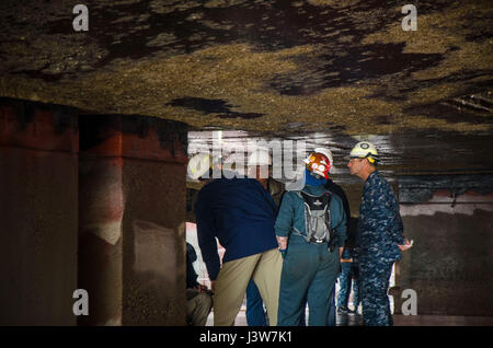 PORTLAND, Ore. (May 2, 2017) - Capt. Drew St. John, commanding officer, USS Frank Cable (AS 40),  along with civilian mariners and contractors inspect Frank Cable's keel, as she drains in dry-dock, in Portland, Ore., May 2nd.  Frank Cable is in Portland, Ore. for a scheduled dry-dock phase maintenance availability.  (U.S. Navy photo by Mass Communication Specialist 3rd Class Alana Langdon/Released) Stock Photo