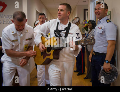 170502-N-GP524-0134  HOLLYWOOD, Fla. (May 2, 2017) Service members visit and perform for patients at the Joe DiMaggio Children’s Hospital during the 27th annual Fleet Week Port Everglades. Fleet Week Port Everglades provides an opportunity for the citizens of South Florida to witness first-hand the latest capabilities of today’s maritime services, and gain a better understanding of how the sea services support the national defense of the United States. (U.S. Navy photo by Mass Communication Specialist 2nd Class Bill Dodge/Released) Stock Photo