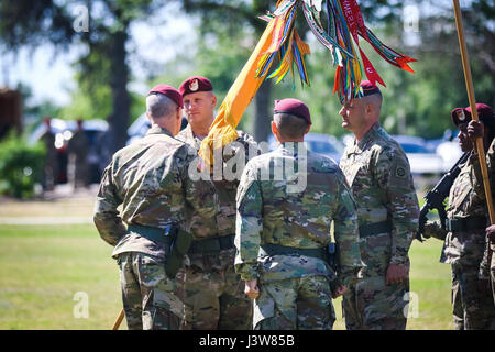 Lt. Col. Jonathan Tackaberry, the incoming commander of 1st Squadron, 17th Cavalry Regiment, 82nd Combat Aviation Brigade, receives the squadron colors from Col. Erik Gilbert, commander of the 82nd CAB, during a change of command ceremony on Stan Field on Fort Bragg, N.C., May 4. (U.S. Army Photo by Capt. Adan Cazarez) Stock Photo