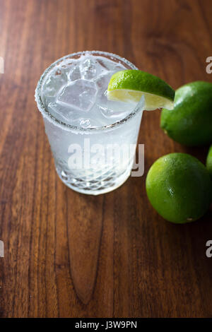 Margarita on the rocks with salt next to a few limes Stock Photo