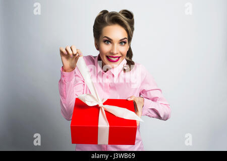 Happy beautiful funny woman unpacks gift Stock Photo