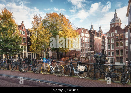 The canal houses along the junction of the canals Oudezijds Voorburgwal and Oudezijds Achterburgwal  in the old center of Amsterdam Stock Photo