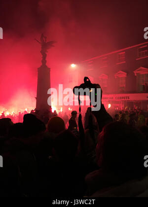 Lewes, England - 5 November 2016: Dark and crowded streets of Lewes are covered in smoke due to the explosions and fire parade. Stock Photo