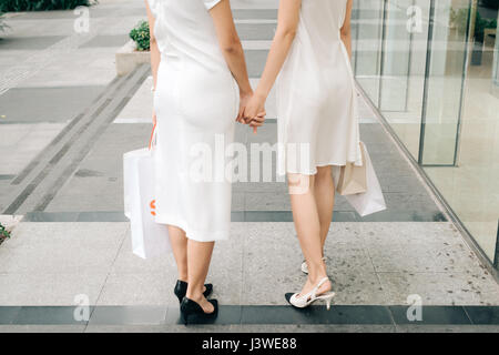 Beautiful asian girls with shopping bags walking on street at the mall Stock Photo