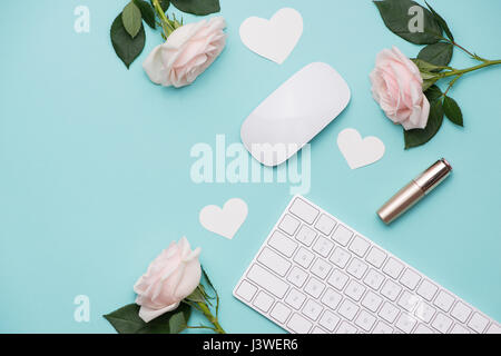 Mother's Day concept. Pink roses with gift box on woman office desk. Open notebook for copy space. Stock Photo