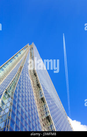 The Shard skyscraper from below with a plane going past, London Bridge, London Stock Photo