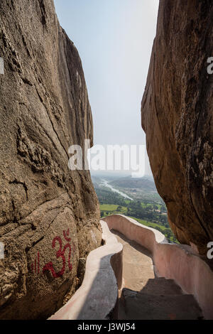 Hampi village seen through big boulders, view from Anjaneya hills, Hampi. Stock Photo