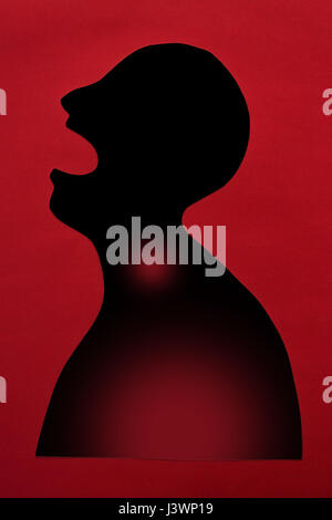 concept of sickness and pain on silhouette - abstract african patient with infectious disease in lungs, risk of contracting Ebola through an open mouth, isolated on red background, top view, flat lay. Stock Photo