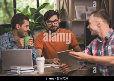 Young men programmers working together in the office  Stock Photo