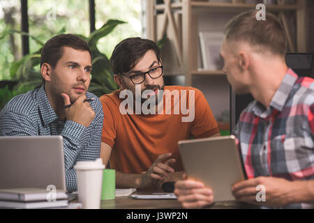 Young men programmers working together in the office  Stock Photo