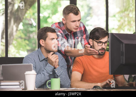 Young men programmers working together in the office  Stock Photo