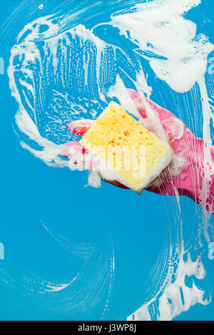 Hand with glove cleaning window Stock Photo